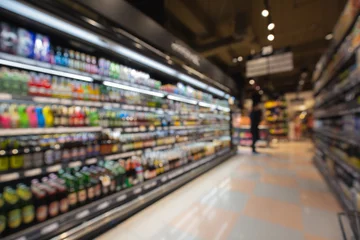 Fototapeten Defocused blur of supermarket shelves with alcohol products © chitsanupong