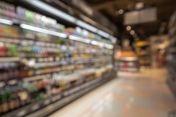 Foto op Plexiglas Defocused blur of supermarket shelves with alcohol products © chitsanupong