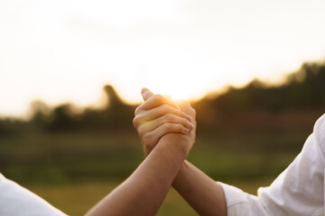 Friends touch - hold hands together.