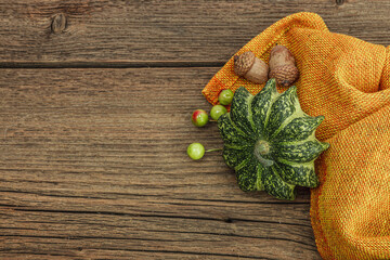 Autumn composition on orange background. Assortment of decorative pumpkins, berries and fall leaves