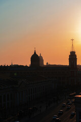 Panoramic view of the roofs, towers, domes of churches and cathedrals silhouetted against sunset light on spring evening. Saint-Petersburg, Russia. Travelling and tourism concept. Copy space.