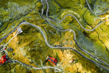 Aerial view of cabin by winding road in mountains