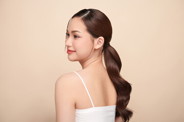 Fototapeta premium Beautiful young asian woman with clean fresh skin on beige background, Face care, Facial treatment, Cosmetology, beauty and spa, Asian women portrait.
