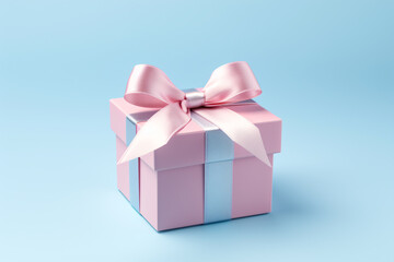 Obraz premium Beautiful pink gift box with pink ribbon bow isolated on blue background, Valentine s day and New year promotion offer concept.