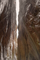 Narrow limestone gorge, towering walls, nature's sculpted beauty. Natural background for your design.