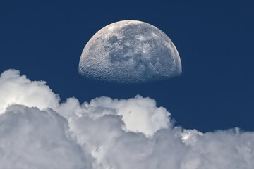 moon in the blue sky with white clouds