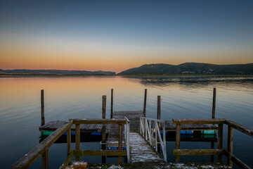 Knysna Lagoon with jetty and fishing boats at sunset in the Garden Route South Africa