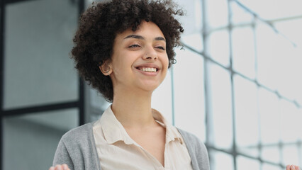 girl in the office smiles expresses success and leadership is thinking about success