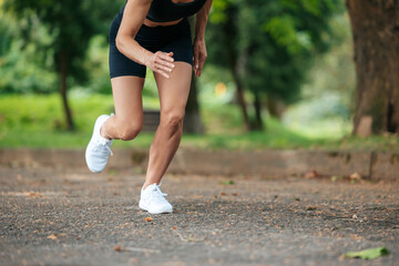 Unrecognizable slim athletic woman running on road.