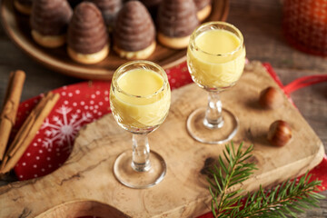 Eggnog in glass cups with wasp nests or beehives - traditional Christmas cookies