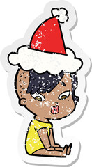 hand drawn distressed sticker cartoon of a surprised girl wearing santa hat