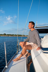 Man on a yacht smiling and feeling peaceful
