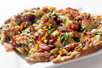 Delicious pizza with bacon pears brie cheese sunflower sprout and seeds with balsamic