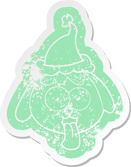 quirky cartoon distressed sticker of a dog face panting wearing santa hat