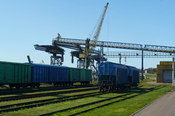 Freight cars stand on the railway waiting to be loaded.