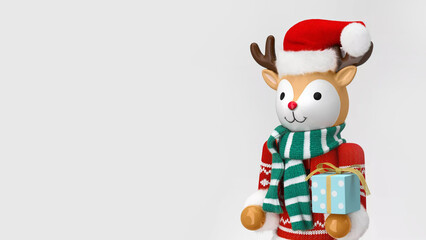 Closeup of figural deer Christmas nutcracker holding presents, isolated on copy-space background.