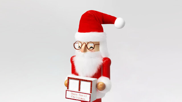 Closeup of Santa Christmas nutcracker with countdown calendar, isolated on copy-space background.