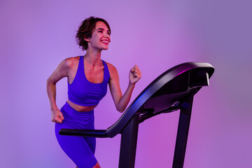 Photo of determined sporty lady run on treadmill fast speed for buying sport equipment sale...
