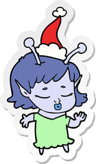cute alien girl hand drawn sticker cartoon of a wearing santa hat