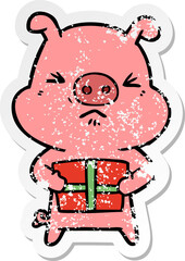 distressed sticker of a cartoon angry pig with christmas present
