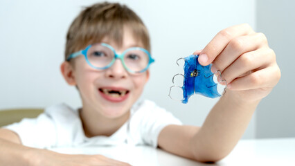 A boy with a dental correction plate