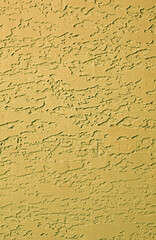 Front view of mustard yellow colored abstract pattern concrete wall