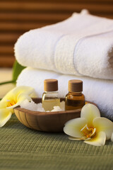 Fototapeta na wymiar Thai Massage Spa Therapy with Herbal Towel Compress Ball, Coconut Oil, Perfume, Cosmetics, and Plumeria Flower on Massage Bed created with Generative Ai