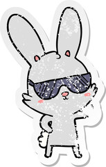 distressed sticker of a cute cartoon rabbit wearing sunglasses