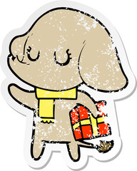 distressed sticker of a cute cartoon elephant with gift