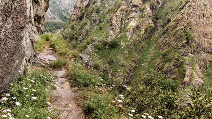 A narrow rocky trail between mountains.