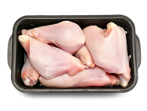 Raw chicken legs in a black plastic tray isolated on transparent or white background, png
