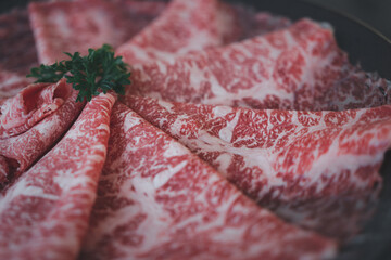 Rare sliced wagyu beef with marbled texture. Close up