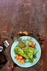 Rolls of spinach pancakes with cheese and shrimps