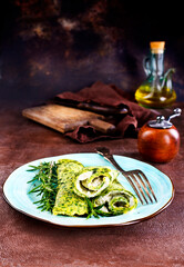 Rolls of spinach pancakes with cheese and shrimps