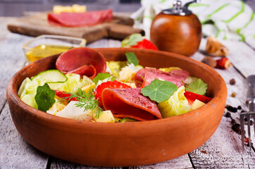 fresh salad with salami and vegetables
