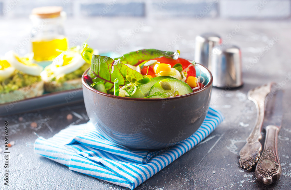 Wall mural green vegan salad from green leaves mix and vegetables. diet food