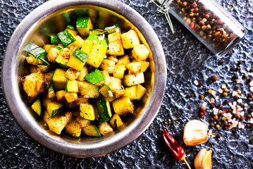 Sliced spiced zucchini with oil, salt and garlic
