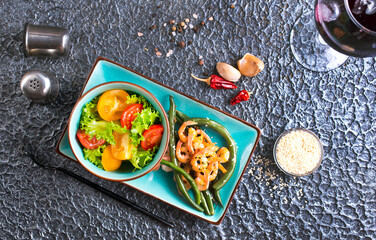 Healthy salad plate. Fresh seafood recipe. Grilled shrimps and fresh vegetable salad.