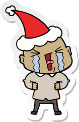 hand drawn sticker cartoon of a crying bald man wearing santa hat