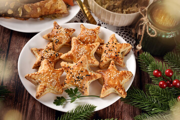 Fototapeta na wymiar Star shaped puff pastry pies with mushroom filling for Christmas Eve supper top view