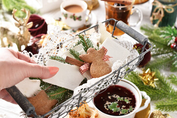 A wire basket with Christmas Eve wafer held above the table with traditional dishes
