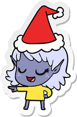 happy hand drawn sticker cartoon of a elf girl pointing wearing santa hat