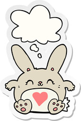 cute cartoon rabbit with love heart with thought bubble as a printed sticker