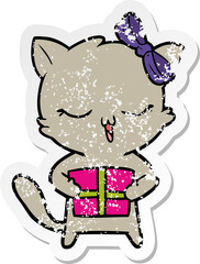 distressed sticker of a cartoon girl cat with christmas present