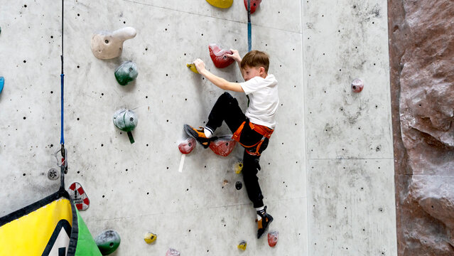 a boy or a girl on a climbing wall