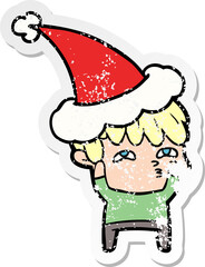 hand drawn distressed sticker cartoon of a curious man wearing santa hat