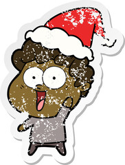 hand drawn distressed sticker cartoon of a happy man wearing santa hat