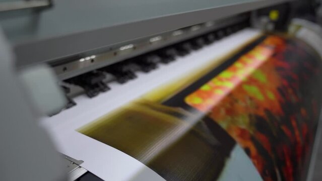 Plotter printing. Printing services and printing. The plotter prints the image.