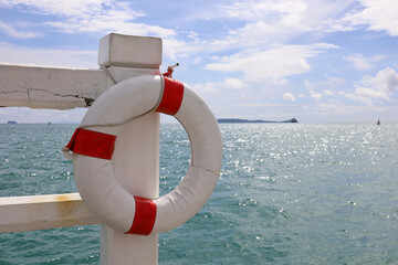 White lifebuoy on a beach. Safety on a water, life ring on sea background