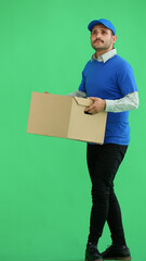 full-length male courier holding a box on a green background